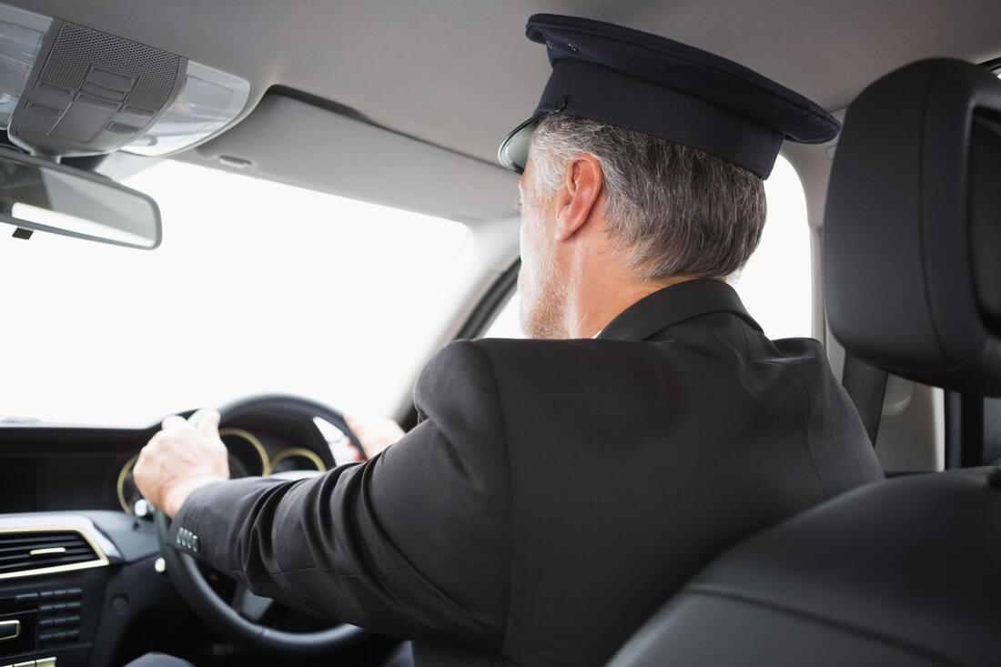 Airport transfer service driver in uniform and driving